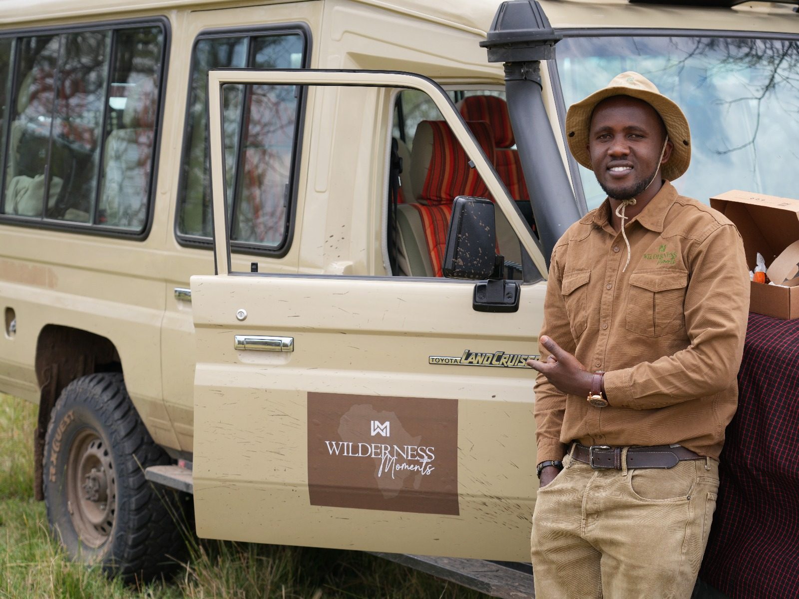 Wilderness Moments guide leaning on the Land Cruiser